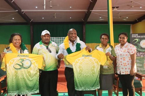 DWU alumni holding 30th anniversary jerseys with Prime Minister James Marape