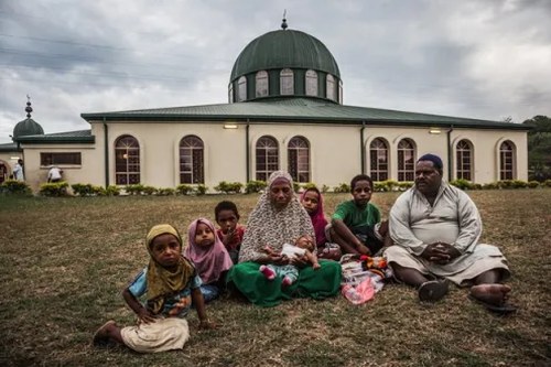 A Muslim family sitting outside a mosque in Papua New Guinea